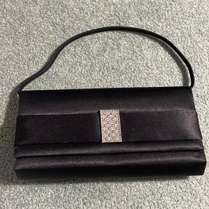 Black clutch with gem details. Includes short and long strap.